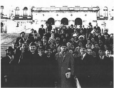 Malcolm surrounded by Charles Rangel (left) , Percy Sutton (right), and others on the steps of the State Building in Albany New York after Sutton's election to the State Assembly.