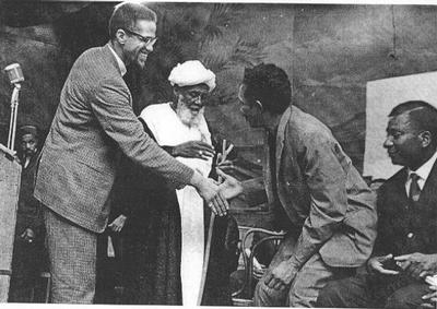 Malcolm X at the Audobon Ballroom with Sheik Hassen from Mecca and Abu Rahman Mohammad Babu, Tanzanian revolutionary.