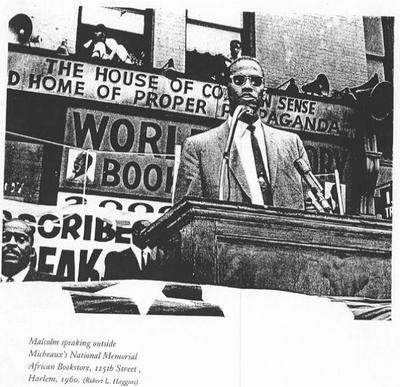 Malcolm speaks outside Micheaux's National Memorial Bookstore on 125th Street in Harlem.